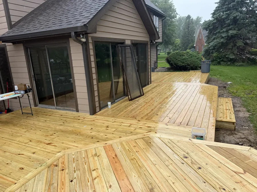 A finished multi-level wooden deck, freshly stained.